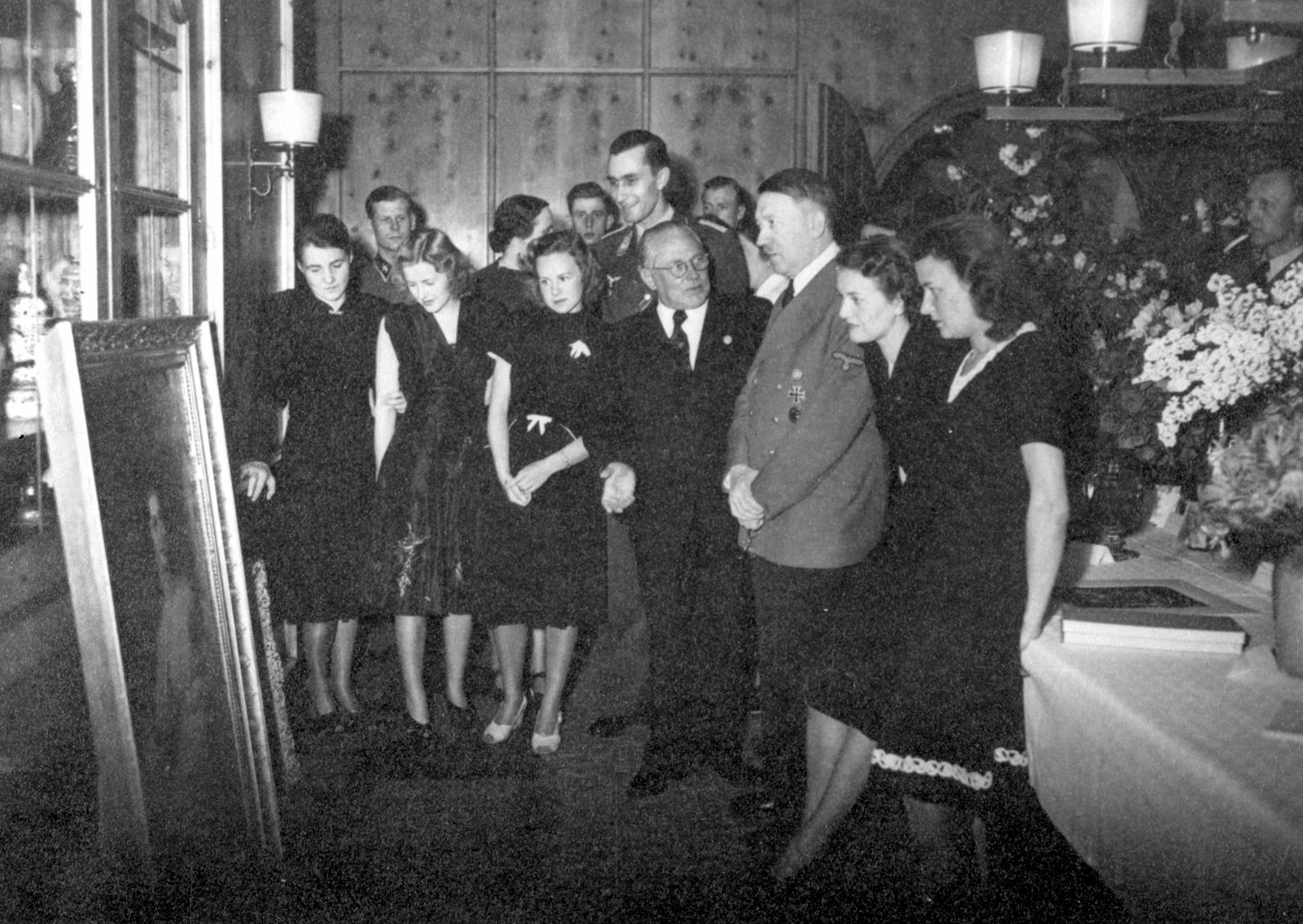 Adolf Hitler and Eva Braun look at a gift painting on the occasion of the 54th birthday of the Führer, from Eva Braun's albums